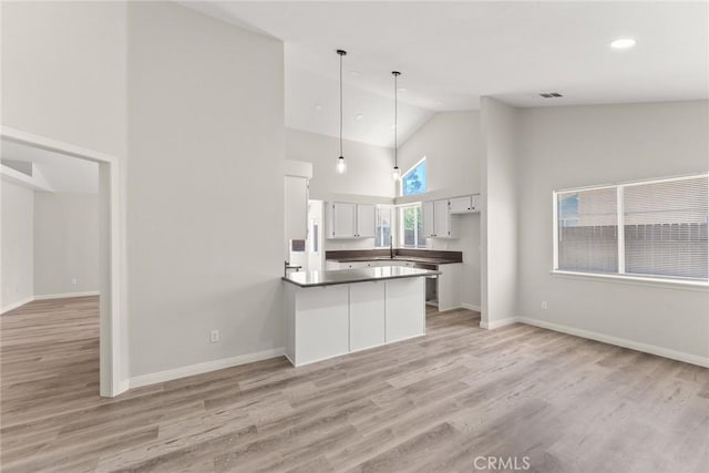 1318 Washington Ave, San Jacinto, CA 92583 - kitchen with high vaulted ceiling, a peninsula, light wood-style floors, open floor plan, and recessed lighting