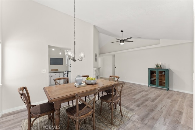 1318 Washington Ave, San Jacinto, CA 92583 - dining area with light wood-style floors, baseboards, ceiling fan, a chandelier, and high vaulted ceiling