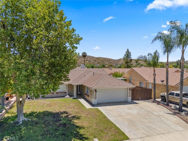 1318 Washington Ave, San Jacinto, CA 92583 - ranch-style home featuring an attached garage, a tile roof, concrete driveway, stucco siding, and a mountain view