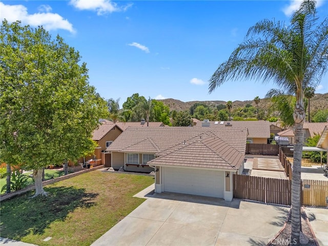 1318 Washington Ave, San Jacinto, CA 92583 - ranch-style home with a tile roof, an attached garage, concrete driveway, stucco siding, and a mountain view