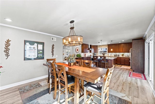 1050 Shelburne Ln, Habra, CA 90631 - dining space featuring light wood-style flooring, a chandelier, baseboards, recessed lighting, and ornamental molding