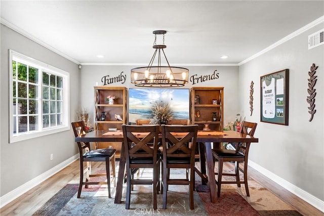 1050 Shelburne Ln, Habra, CA 90631 - dining space with crown molding, wood finished floors, a chandelier, baseboards, and recessed lighting