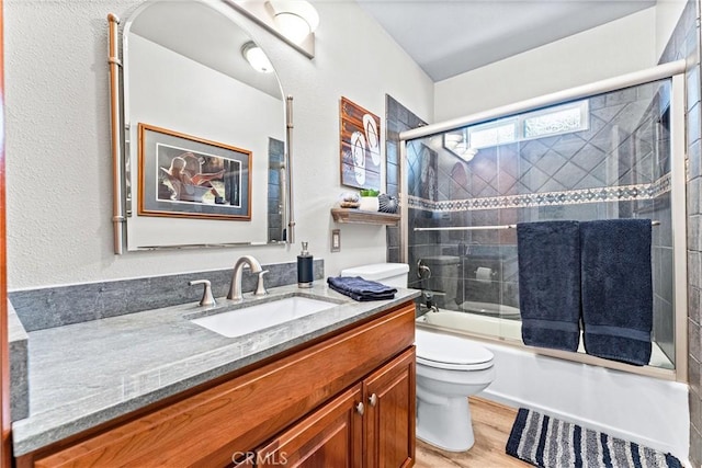 1050 Shelburne Ln, Habra, CA 90631 - full bathroom with toilet, vanity, wood finished floors, and enclosed tub / shower combo
