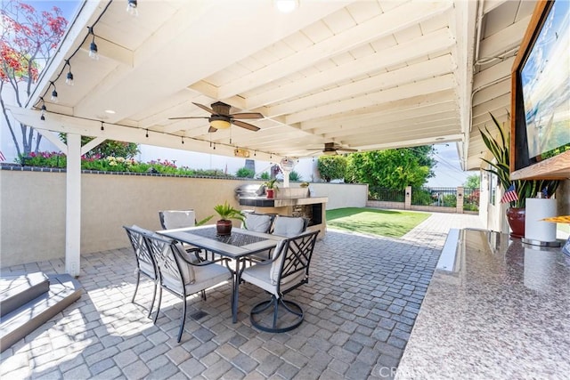 1050 Shelburne Ln, Habra, CA 90631 - fenced backyard with outdoor dining area, a ceiling fan, and a patio