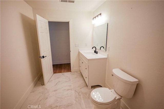 417 S Murdock Ave, Willows, CA 95988 - bathroom with vanity, toilet, marble finish flooring, and baseboards