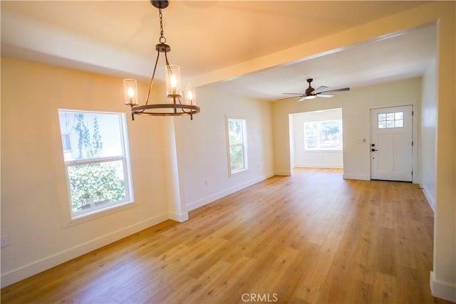 417 S Murdock Ave, Willows, CA 95988 - empty room with a chandelier, baseboards, light wood-style floors, and ceiling fan