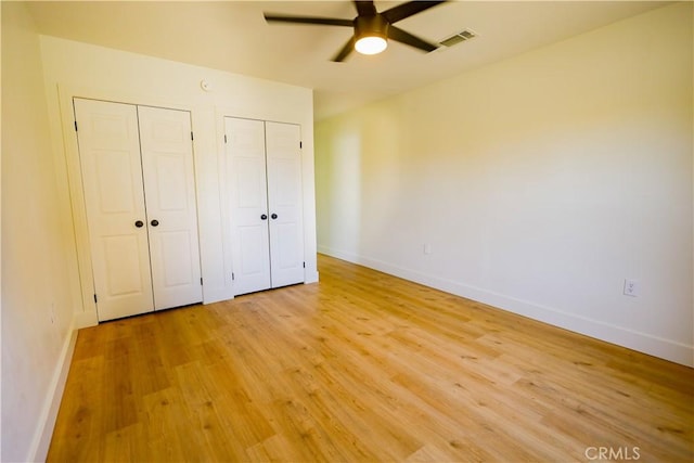 417 S Murdock Ave, Willows, CA 95988 - unfurnished bedroom featuring two closets, light wood-style flooring, and baseboards