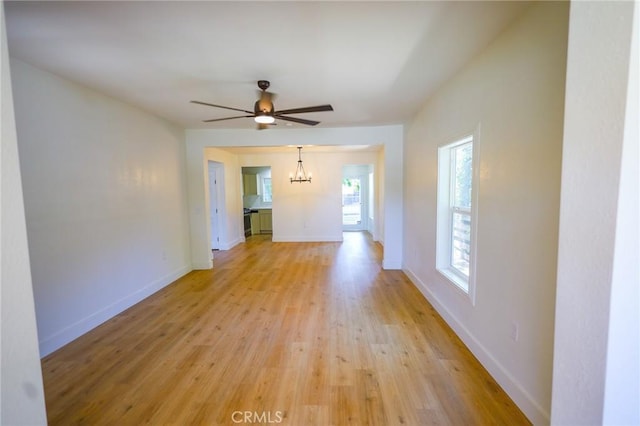 417 S Murdock Ave, Willows, CA 95988 - spare room featuring a chandelier, light wood-type flooring, a ceiling fan, and baseboards