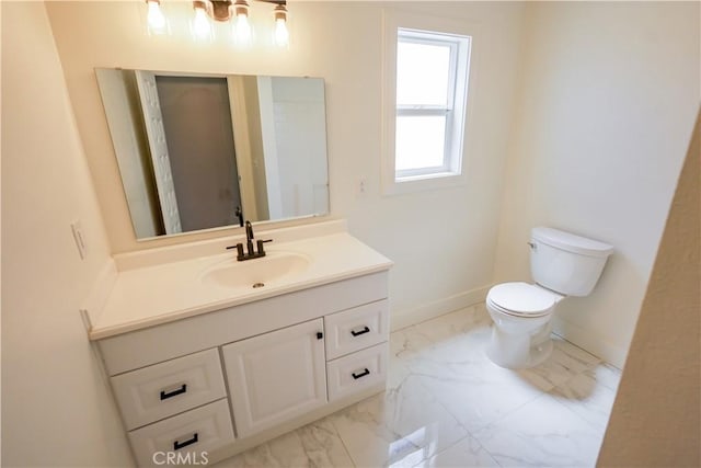 417 S Murdock Ave, Willows, CA 95988 - bathroom featuring marble look tiles, toilet, vanity, and baseboards