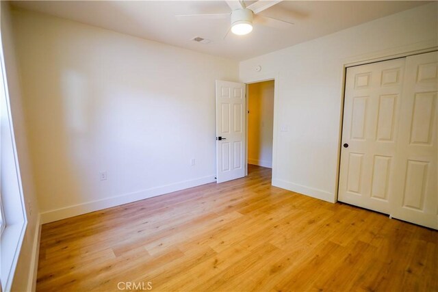 417 S Murdock Ave, Willows, CA 95988 - unfurnished bedroom with light wood-style floors, a closet, baseboards, and a ceiling fan