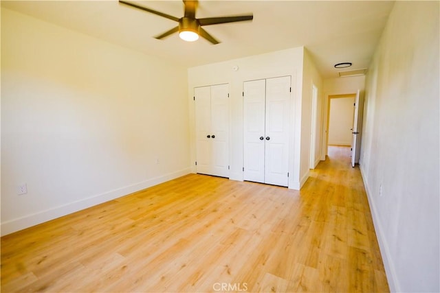 417 S Murdock Ave, Willows, CA 95988 - unfurnished bedroom featuring multiple closets, light wood-type flooring, baseboards, and a ceiling fan