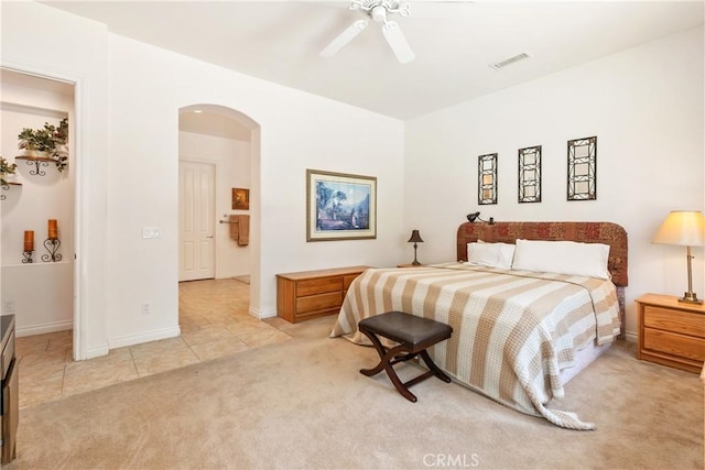 11538 Stoney Brook Ct, Beaumont, CA 92223 - bedroom featuring light colored carpet, arched walkways, light tile patterned flooring, baseboards, and ceiling fan