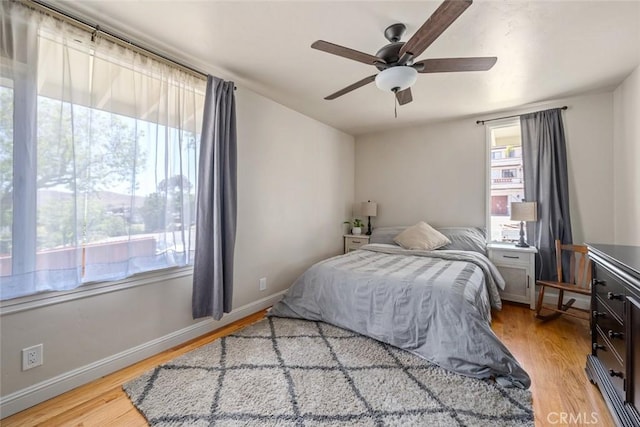 1215 Sylvia Ct, San Luis Obispo, CA 93401 - bedroom with multiple windows, light wood finished floors, and a ceiling fan