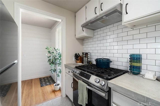 1215 Sylvia Ct, San Luis Obispo, CA 93401 - kitchen featuring appliances with stainless steel finishes, under cabinet range hood, light countertops, white cabinets, and decorative backsplash