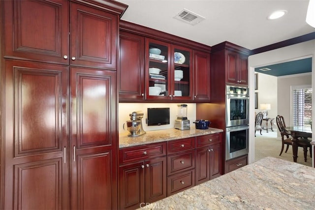 4560 San Antonio Rd, Yorba Linda, CA 92886 - kitchen featuring reddish brown cabinets, stainless steel double oven, light stone counters, carpet flooring, and glass insert cabinets