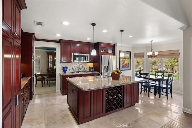 4560 San Antonio Rd, Yorba Linda, CA 92886 - kitchen with dark brown cabinets, stainless steel appliances, baseboards, stone countertops, and an island with sink
