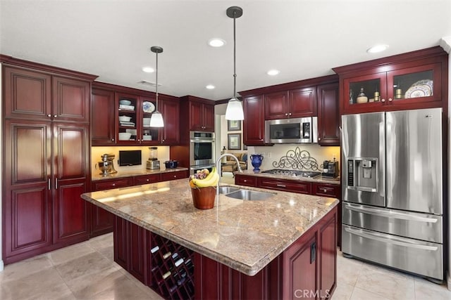 4560 San Antonio Rd, Yorba Linda, CA 92886 - kitchen with stainless steel appliances, dark brown cabinets, a sink, pendant lighting, and an island with sink