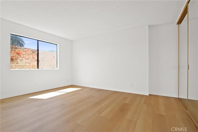 2015 E Broadway Unit 204, Long Beach, CA 90803 - spare room with light wood-style floors, a textured ceiling, and baseboards