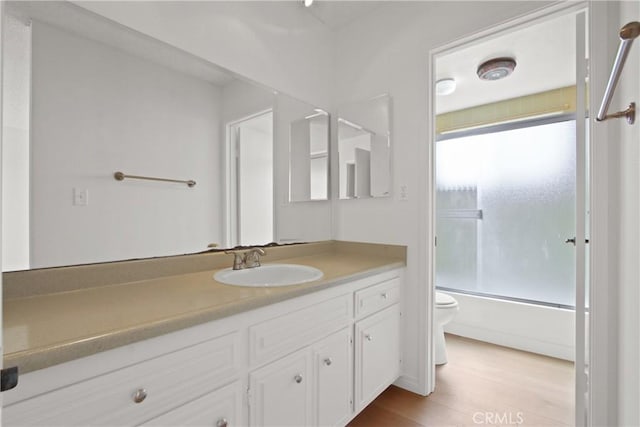2015 E Broadway Unit 204, Long Beach, CA 90803 - bathroom featuring toilet, vanity, wood finished floors, and shower / washtub combination
