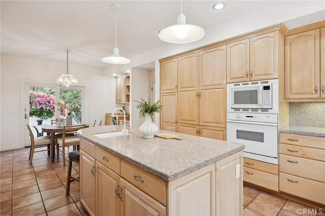 993 Las Palmas Way, San Luis Obispo, CA 93401 - kitchen featuring white appliances, light brown cabinets, a sink, a center island with sink, and light tile patterned floors