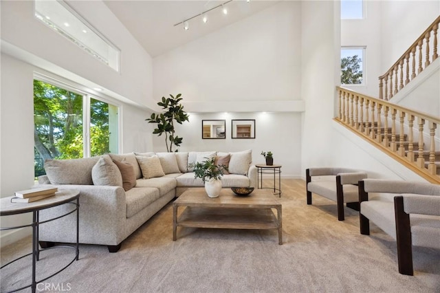 993 Las Palmas Way, San Luis Obispo, CA 93401 - living area featuring high vaulted ceiling, carpet flooring, rail lighting, stairs, and baseboards