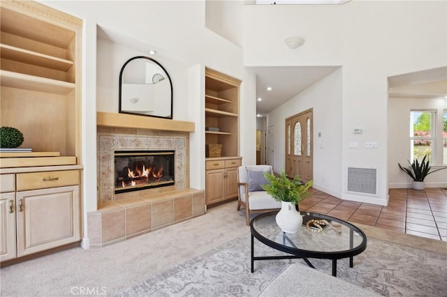 993 Las Palmas Way, San Luis Obispo, CA 93401 - tiled living area featuring a fireplace, built in shelves, baseboards, and a high ceiling