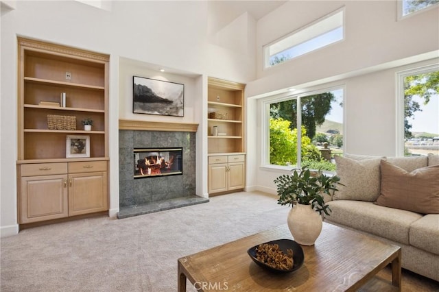 993 Las Palmas Way, San Luis Obispo, CA 93401 - living room featuring a fireplace, light carpet, baseboards, a high ceiling, and built in shelves