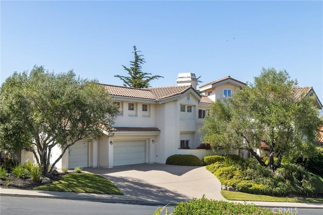 993 Las Palmas Way, San Luis Obispo, CA 93401 - mediterranean / spanish house with a tiled roof, stucco siding, driveway, a garage, and a chimney