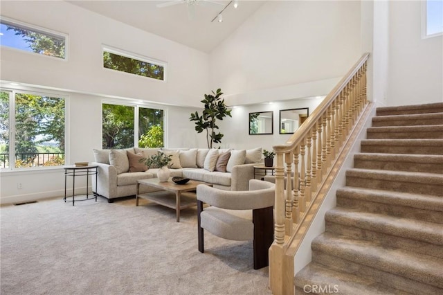 993 Las Palmas Way, San Luis Obispo, CA 93401 - carpeted living room with a towering ceiling, plenty of natural light, stairway, ceiling fan, and track lighting