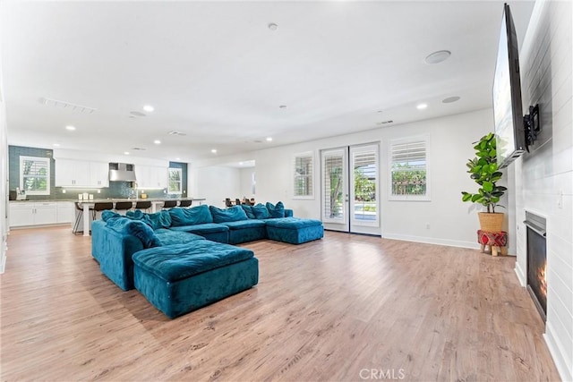 17150 Vita Way, Riverside, CA 92503 - living room featuring recessed lighting, light wood-style floors, a fireplace, and baseboards