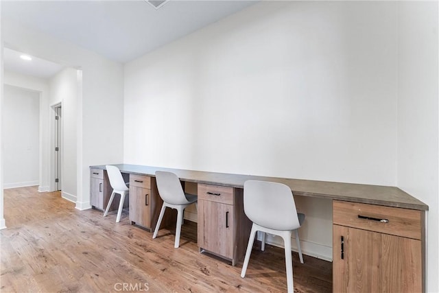 17150 Vita Way, Riverside, CA 92503 - office area featuring built in study area, light wood-style flooring, and baseboards