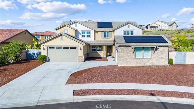 17150 Vita Way, Riverside, CA 92503 - traditional-style house featuring solar panels, stone siding, concrete driveway, an attached garage, and a residential view