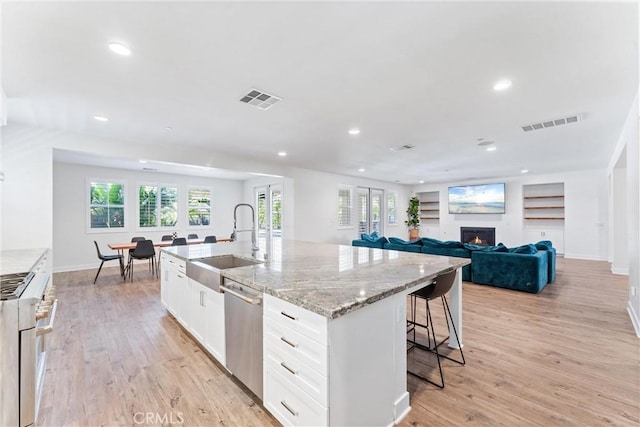 17150 Vita Way, Riverside, CA 92503 - kitchen featuring a sink, high end white range oven, stainless steel dishwasher, recessed lighting, and light stone counters