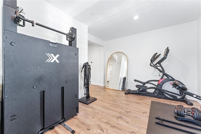 17150 Vita Way, Riverside, CA 92503 - exercise room with light wood finished floors, arched walkways, and baseboards
