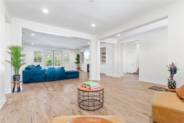 17150 Vita Way, Riverside, CA 92503 - living area featuring light wood finished floors, recessed lighting, baseboards, and stairway