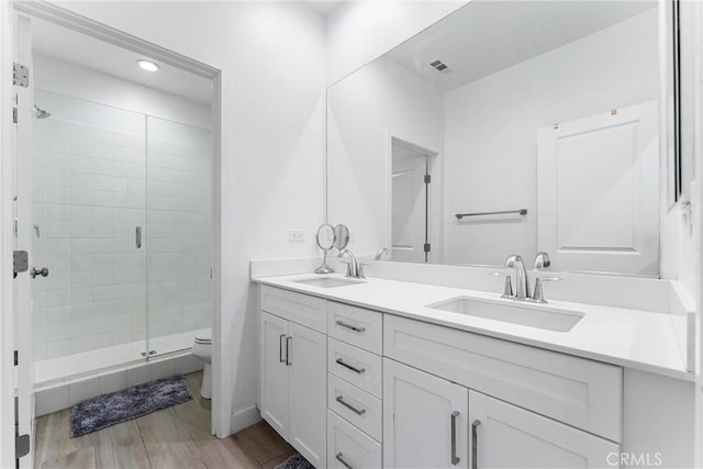 17150 Vita Way, Riverside, CA 92503 - full bathroom with toilet, double vanity, a shower stall, wood finished floors, and recessed lighting