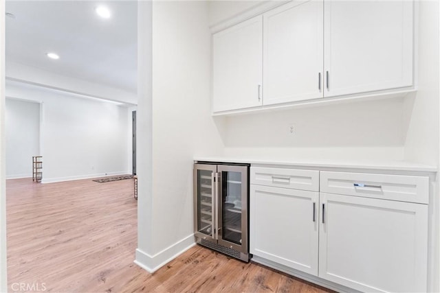 17150 Vita Way, Riverside, CA 92503 - indoor dry bar featuring wine cooler, baseboards, light wood-style flooring, and recessed lighting