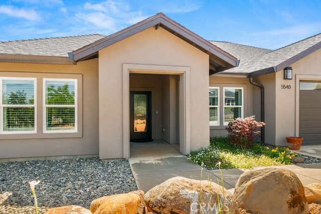 5540 Scottwood Rd, Paradise, CA 95969 - view of exterior entry featuring stucco siding and roof with shingles