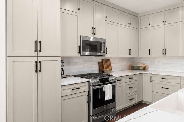 5540 Scottwood Rd, Paradise, CA 95969 - kitchen featuring appliances with stainless steel finishes, decorative backsplash, and white cabinetry