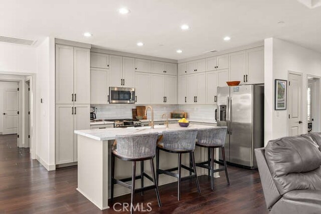 5540 Scottwood Rd, Paradise, CA 95969 - kitchen with appliances with stainless steel finishes, open floor plan, a breakfast bar, light countertops, and dark wood finished floors