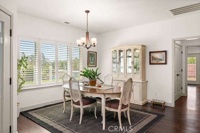 5540 Scottwood Rd, Paradise, CA 95969 - dining room with dark wood-type flooring, a chandelier, and baseboards