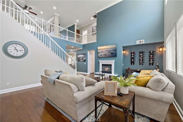 38872 Cherry Point Ln, Murrieta, CA 92563 - living area featuring a high ceiling, ceiling fan, stairs, baseboards, and crown molding