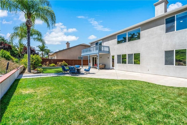 38872 Cherry Point Ln, Murrieta, CA 92563 - rear view of property featuring a balcony, stucco siding, a patio area, and a chimney