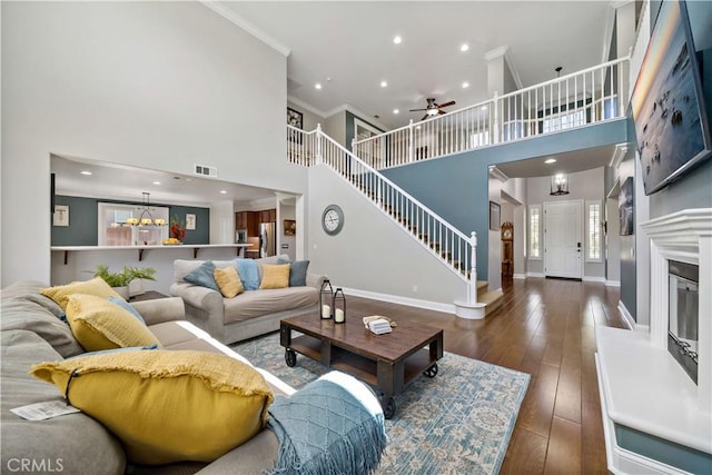 38872 Cherry Point Ln, Murrieta, CA 92563 - living room with crown molding, a towering ceiling, baseboards, ceiling fan, and stairs