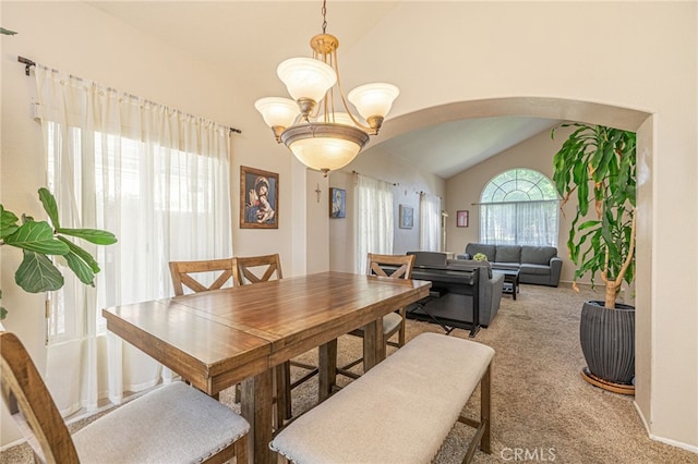5531 Cordiva Ct, Lancaster, CA 93536 - dining space with lofted ceiling, arched walkways, light colored carpet, and a chandelier