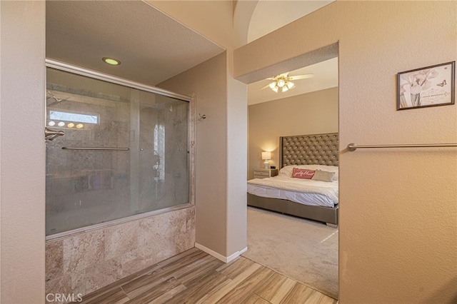 5531 Cordiva Ct, Lancaster, CA 93536 - ensuite bathroom featuring wood finished floors, a ceiling fan, and bath / shower combo with glass door