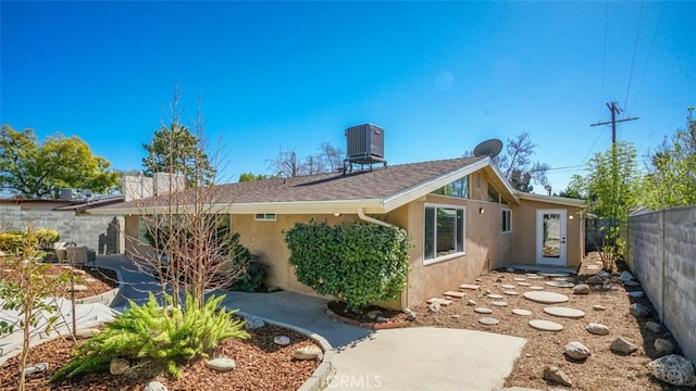 16347 Tupper St, North Hills, CA 91343 - rear view of house with stucco siding and central AC unit