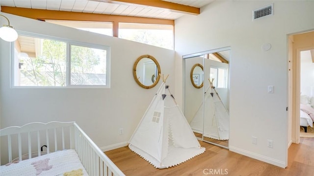 16347 Tupper St, North Hills, CA 91343 - bedroom featuring beam ceiling, multiple windows, light wood-style flooring, a closet, and baseboards