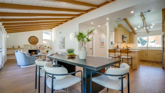 16347 Tupper St, North Hills, CA 91343 - dining area with light wood-style flooring, a tiled fireplace, a chandelier, wooden ceiling, and recessed lighting