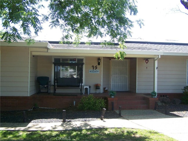 95 Riverview Dr, Oroville, CA 95966 - doorway to property featuring a porch and brick siding